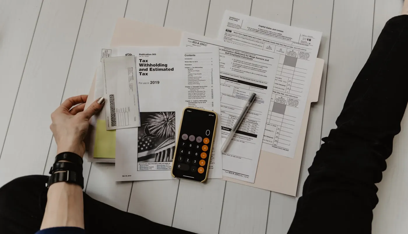 Financial documents and calculator on a professional desk