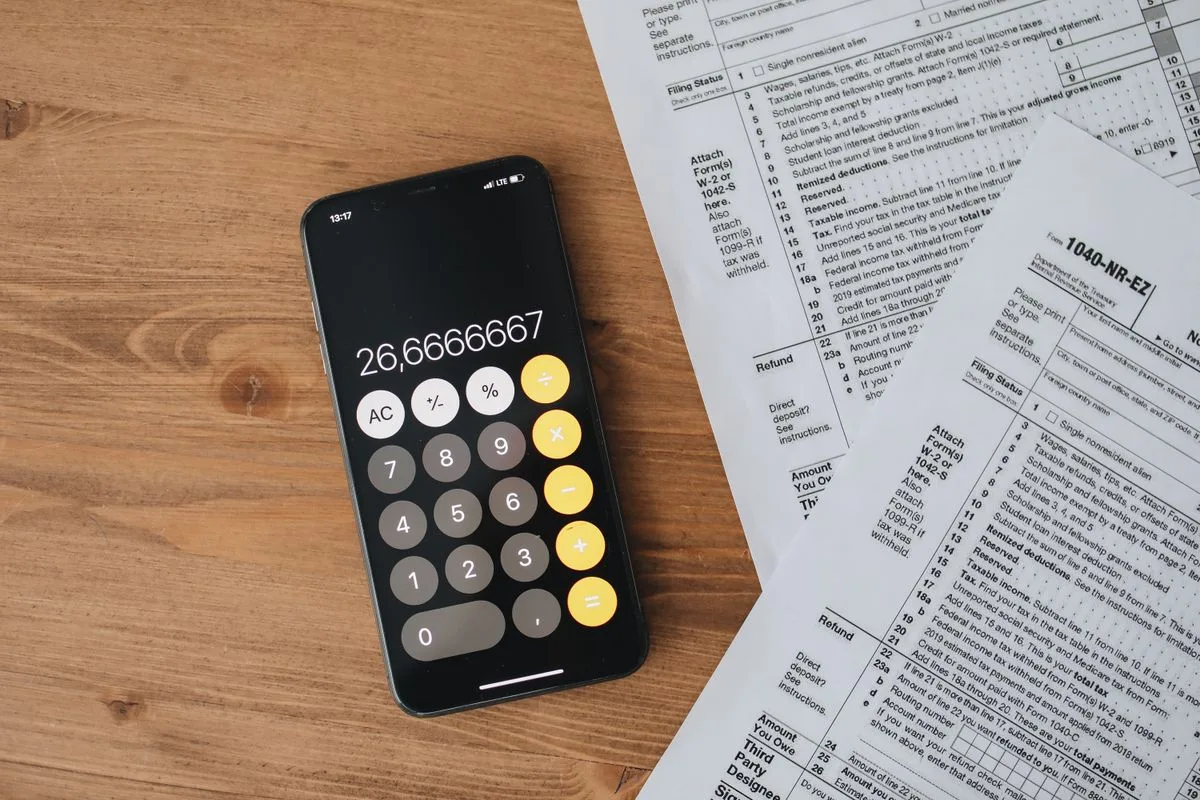 Tax forms and calculator arranged on a professional desk